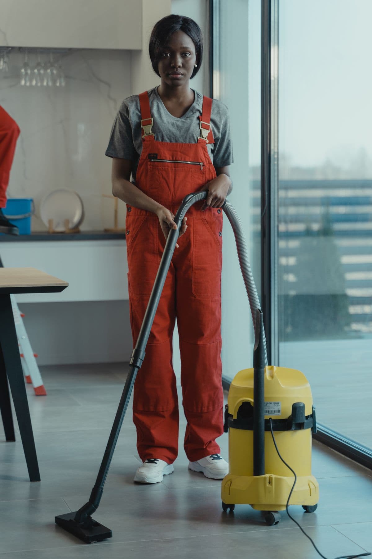 Worker in protective clothing carrying out industrial cleaning.